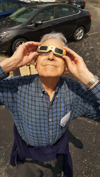 Norman Besheer looking at an eclipse. Norman Celebrates 50 Years At Gunter Pest &amp; Lawn