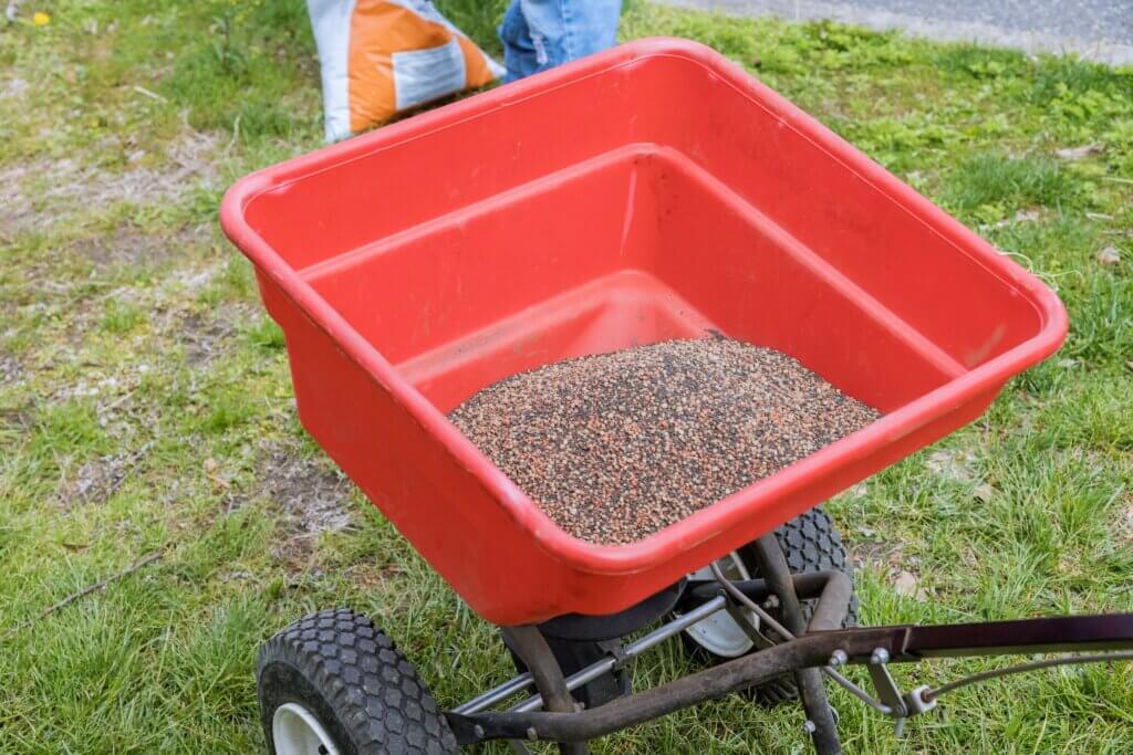 A seeder being used to spot seed a yard in Kansas City, MO.