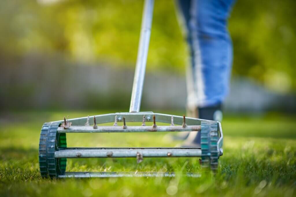 Picture of grass aerator on the green lawn. Kansas City Lawn Aeration. 