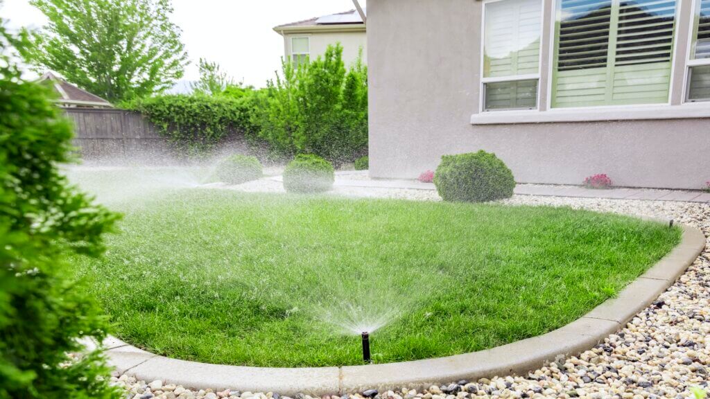 Sprinklers watering lawn in Kansas City area.