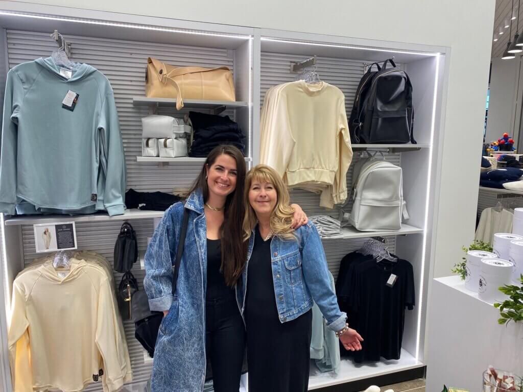 MADI Apparel founder Hayley Santell and her mom Pam Besheer (president of MADI Donations and head of PR) in front of their Kansas City International Airport shop