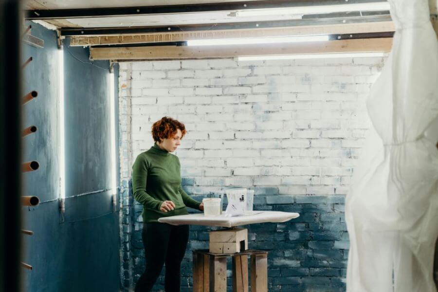 A woman painting her basement. 