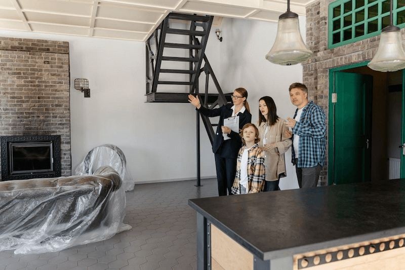 An Agent Showing The Property To The New Homeowners | Gunter Pest & Lawn | Kansas City, MO An agent showing the property to the new homeowners.