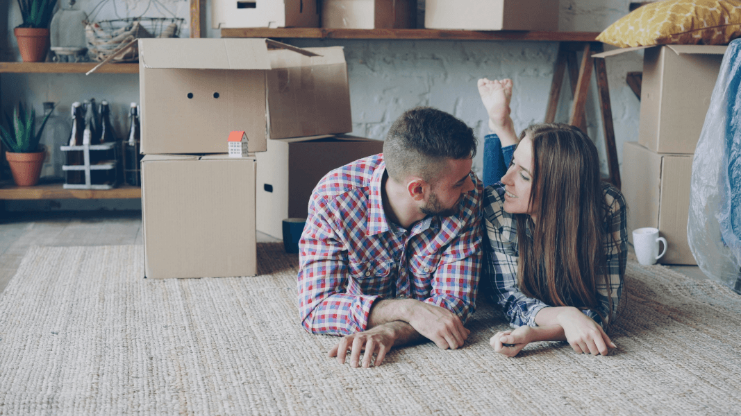 A Young Couple On The Floor Of Their Home | Gunter Pest & Lawn A couple after moving into a new home.