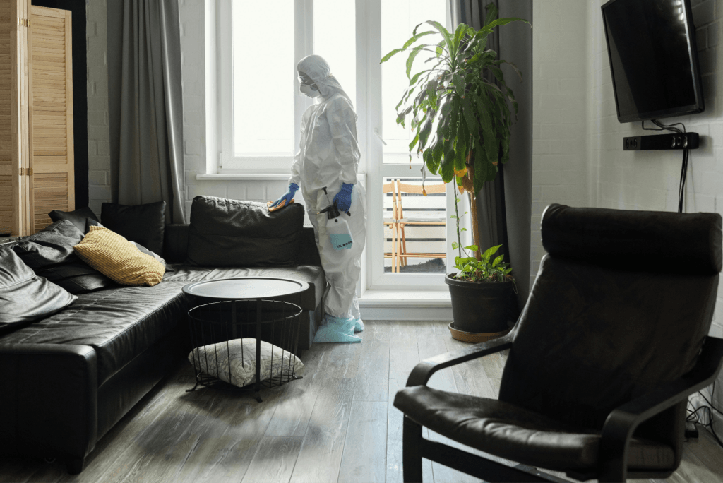 A man sanitizing a room